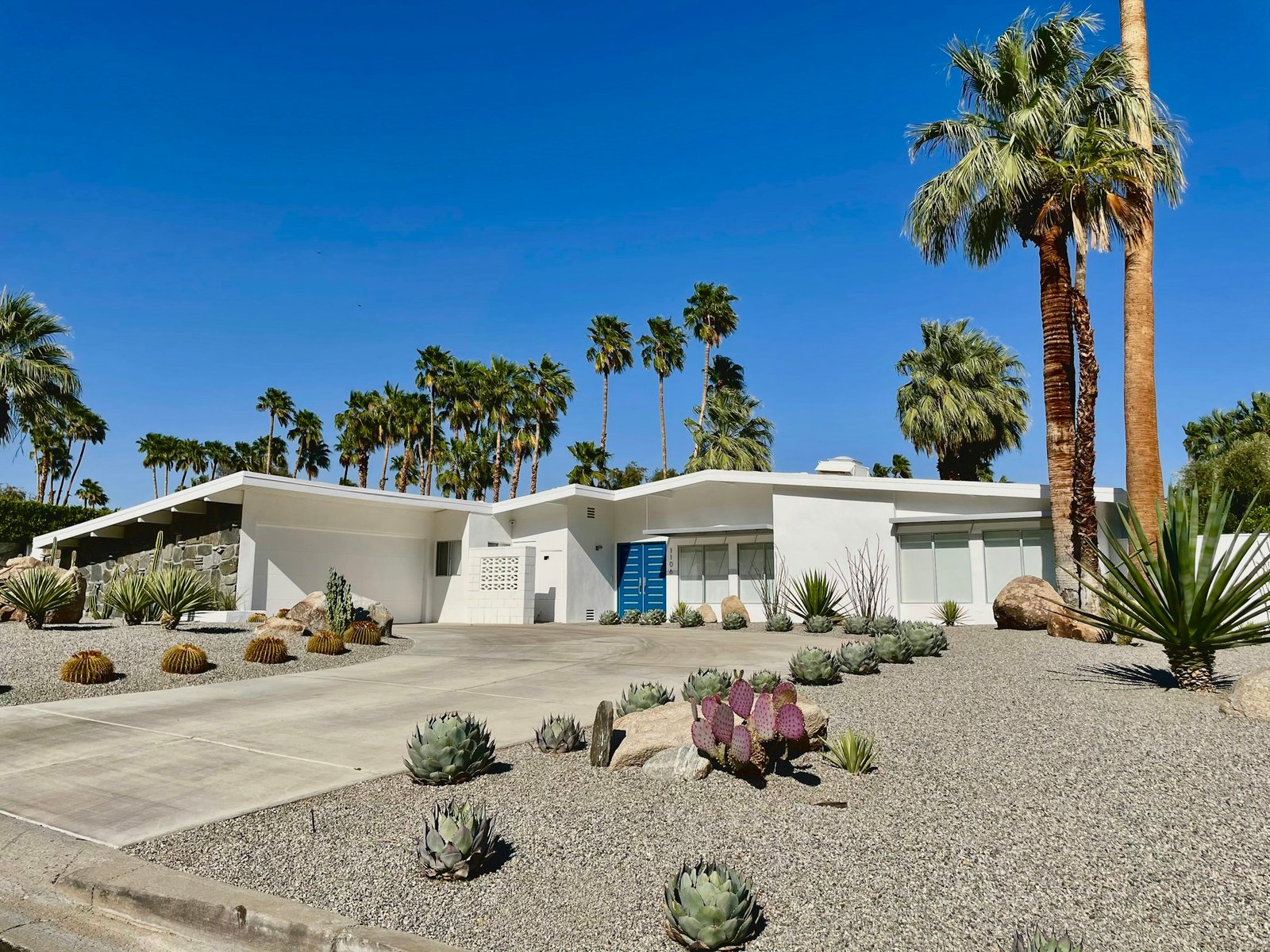 Mid-century home with a low roofline and palm trees
